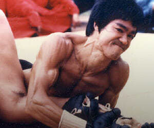 Bruce Lee pinning someone down seeking a submission