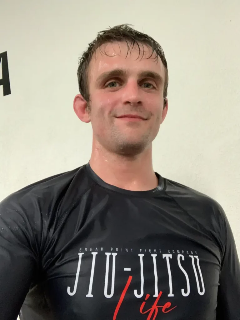 Jordan wearing Jiu Jitsu Life Rash Guard After Training BJJ, sweaty smiling.