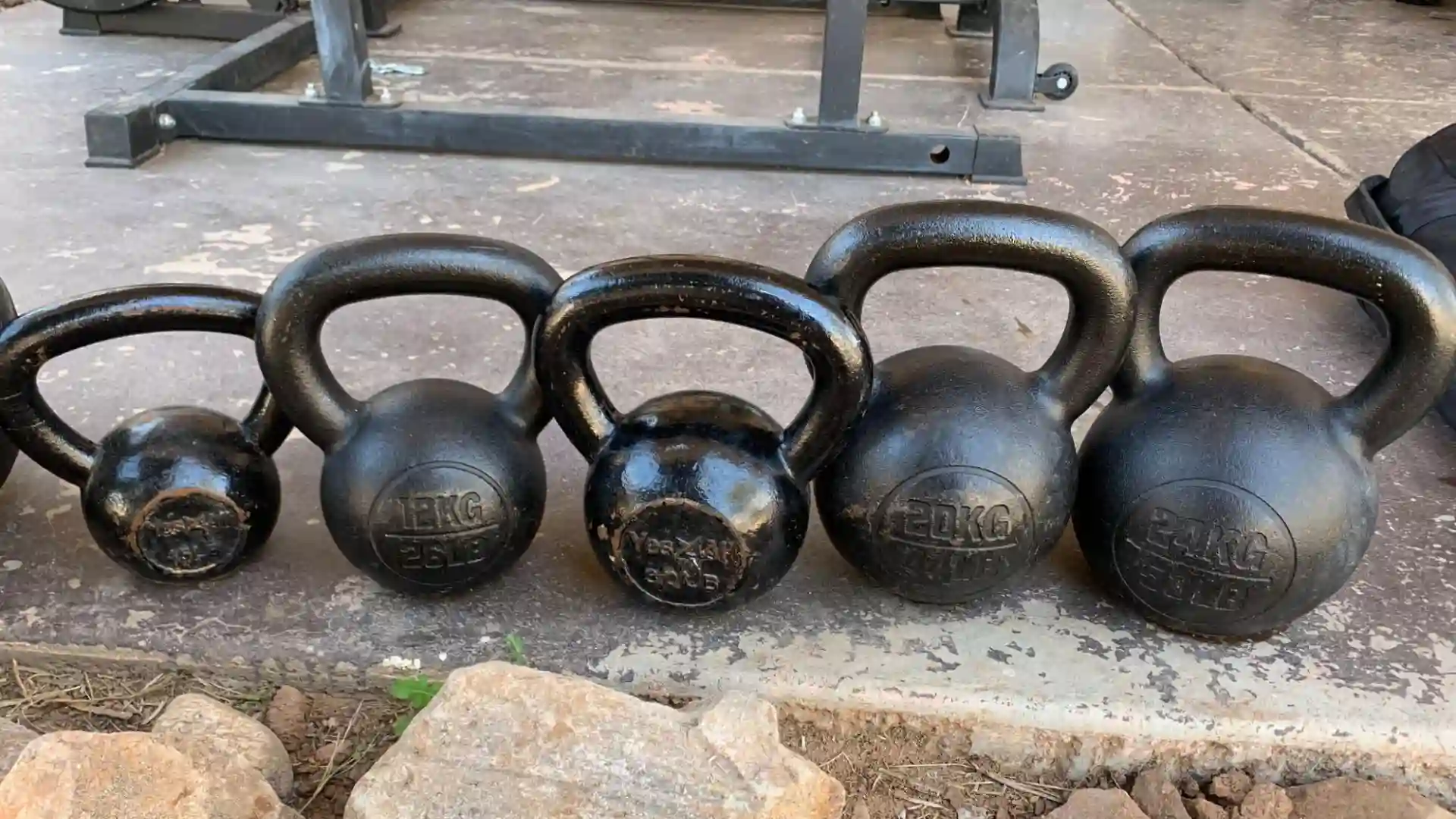 kettlebells in a line on display for bjj exercise